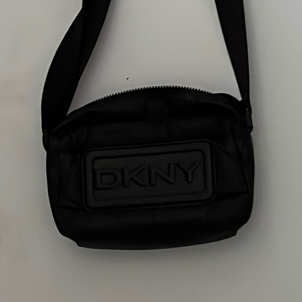 This is an all black dkny shoulder bag still in perfect condition